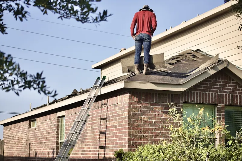 Professional roofer working on a residential roof in Severance